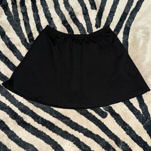 A black skirt with shorts inside and a slight slit on one side.